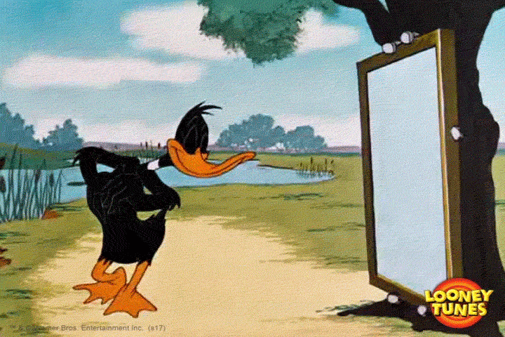 Daffy Duck smiling in a mirror showing his teeth